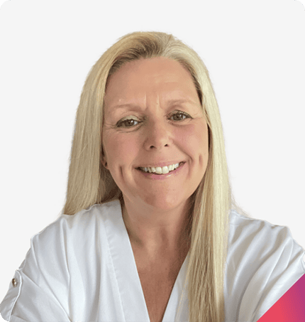 A woman with long blonde hair and a warm smile, wearing a white top, stands against a light background, embodying the essence of positive behavior support plans.