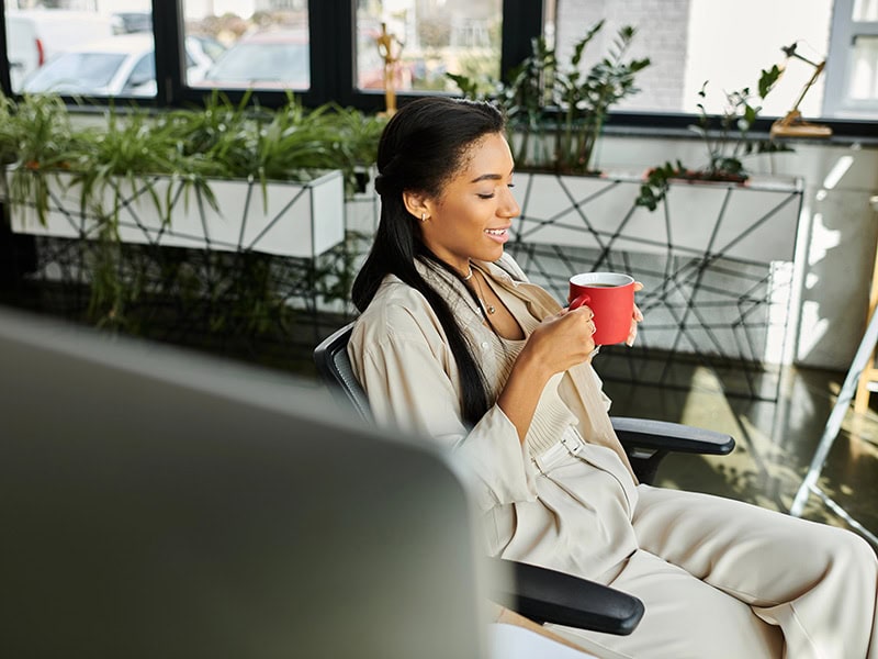 Professional practising mindfulness at work to manage workplace stress and improve wellbeing in a Brisbane workplace.