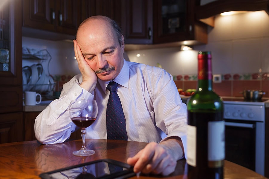 Person in Brisbane experiencing burnout and turning to alcohol for support