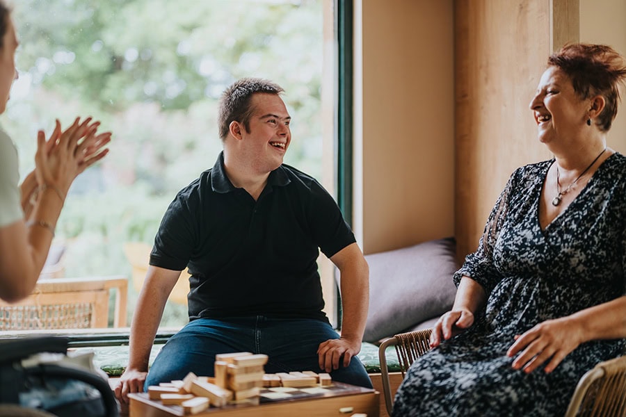 Behaviour support practitioner meeting with family to review behaviour support plans in Queensland