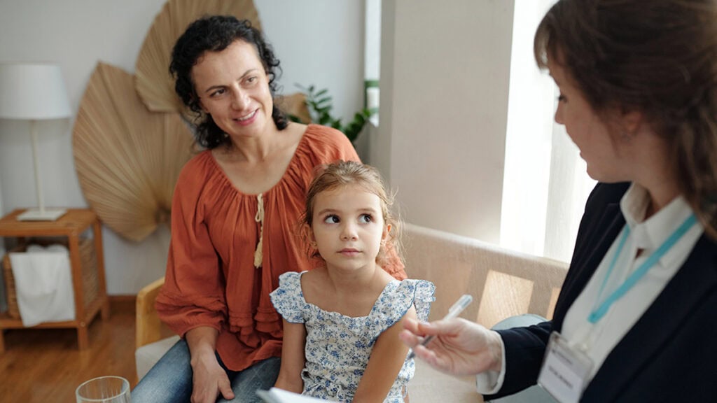 Behaviour support plan implementation consultation with a practitioner, parent and child participant