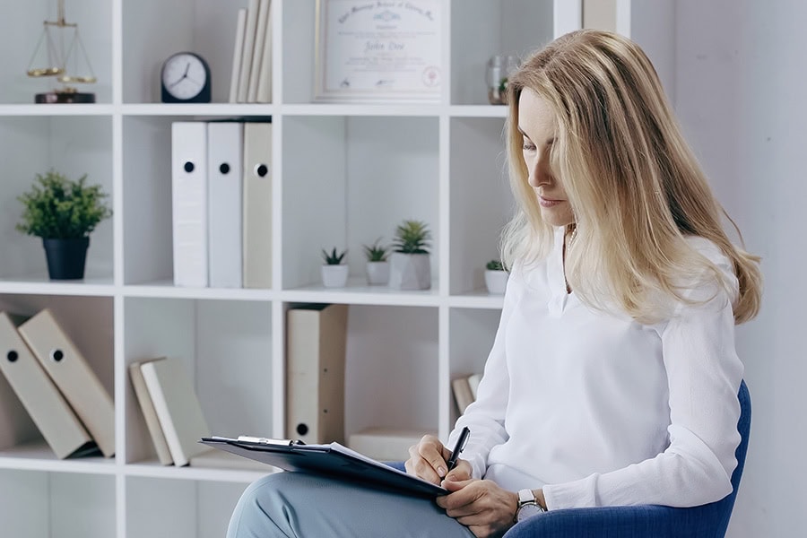 Behaviour support practitioner reviewing a behaviour support plan with notes