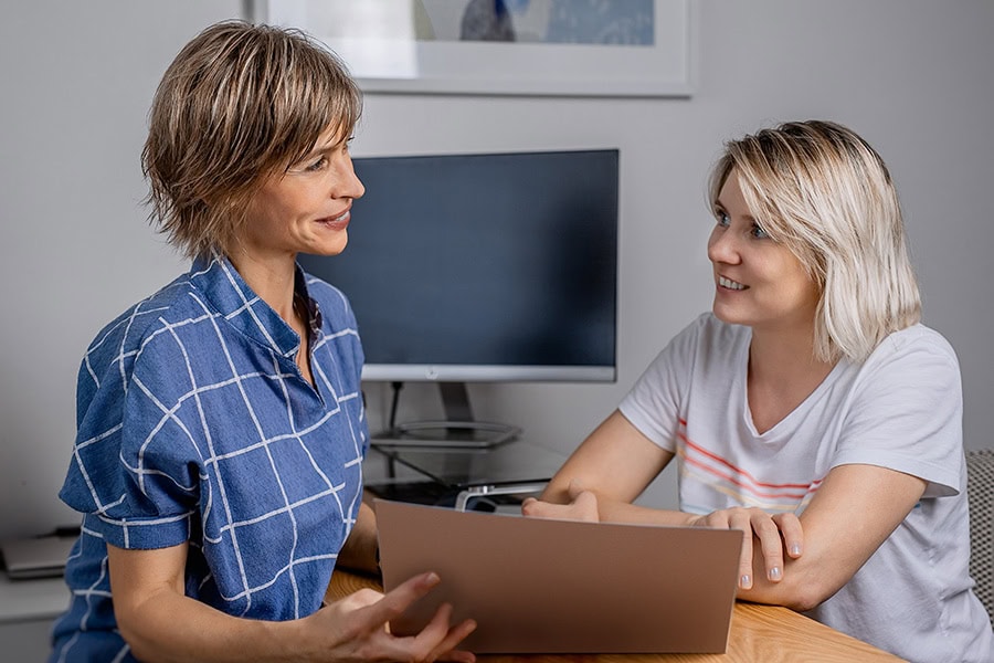 Behaviour Practitioner discussing a Functional Behaviour Assessment with a family member